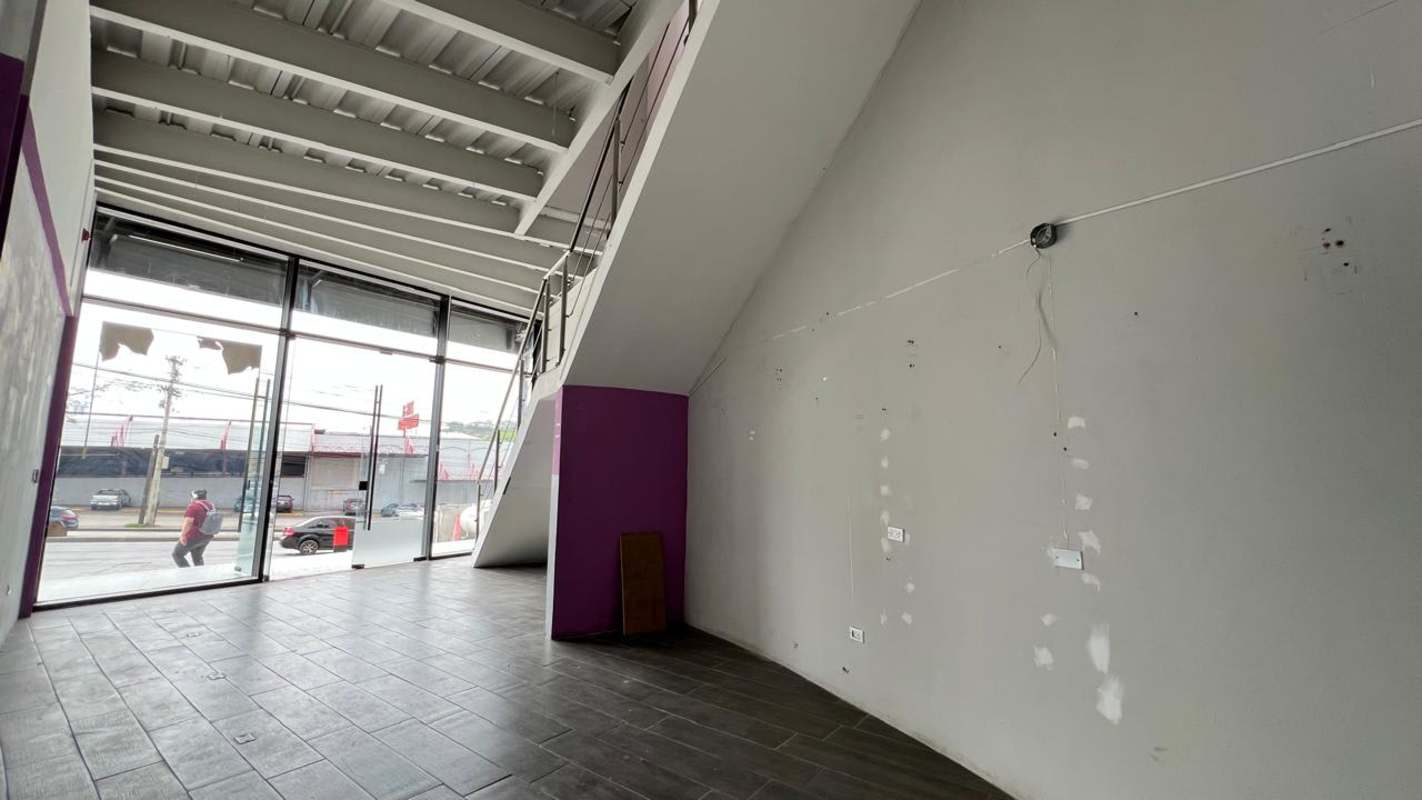 Mezzanine open space commercial interior with metal railing and glass façade Panama City