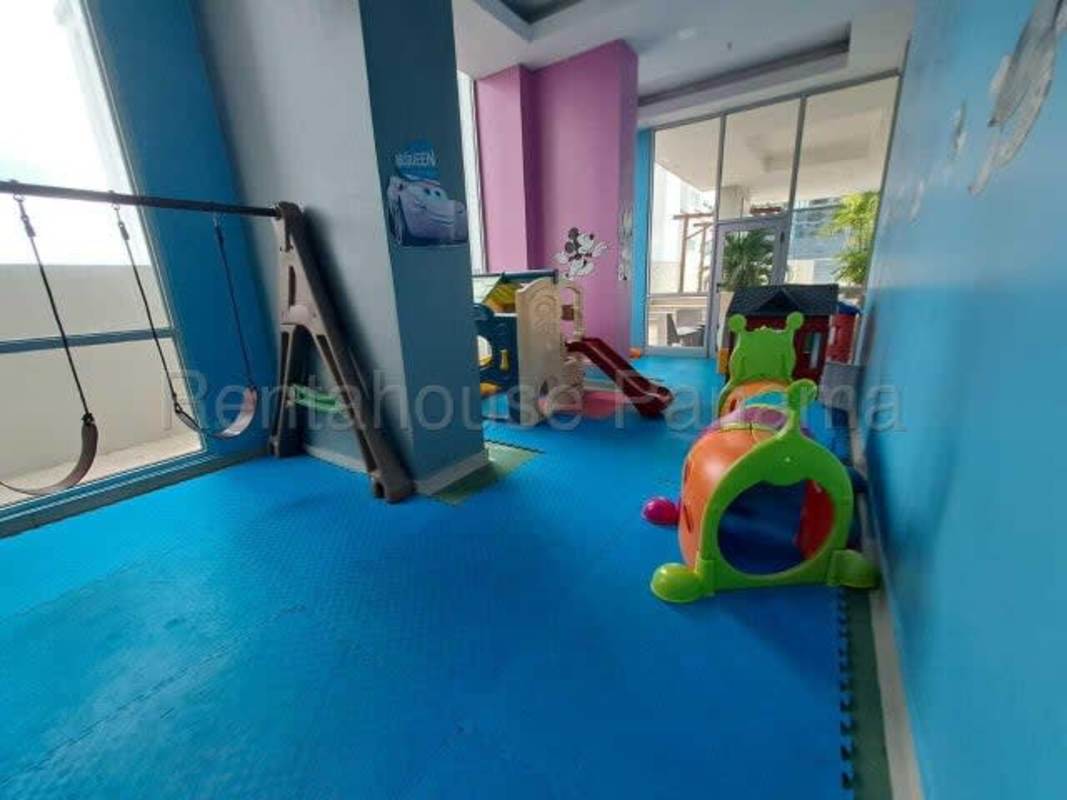Colorful kids playroom with swings, slide, murals in PH Bella Vista Center Bella Vista Panama