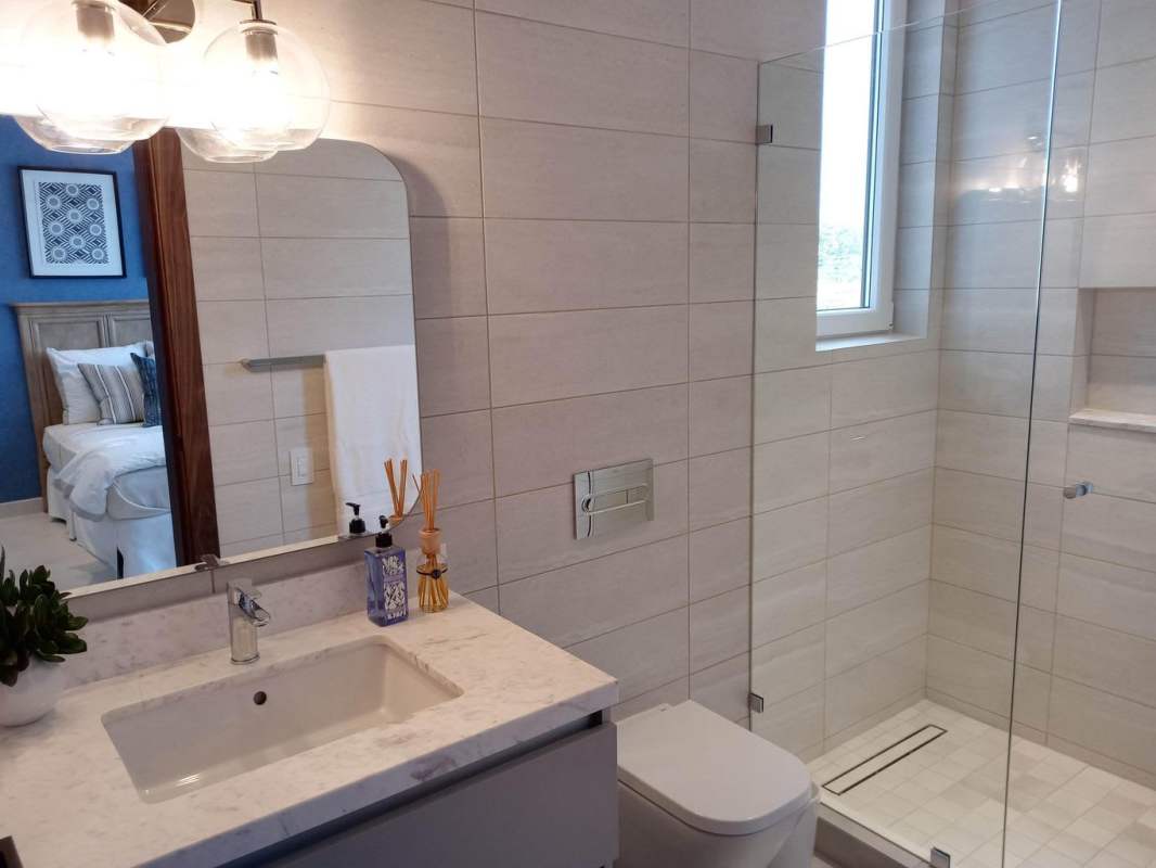 Luxury bathroom with bedroom view, marble countertop, glass shower The Woods Santa Maria
