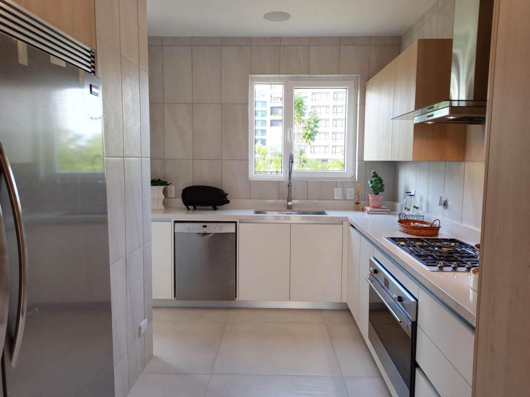 Modern kitchen with stainless appliances light neutral cabinetry Santa Maria Panama