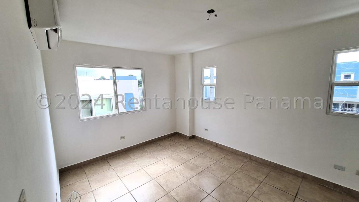 Large outdoor swimming pool with palm trees in Brisas del Golf Panama gated community