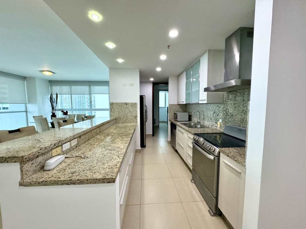 Remodeled kitchen with granite countertops, stainless steel appliances in PH Oceanaire Panama City