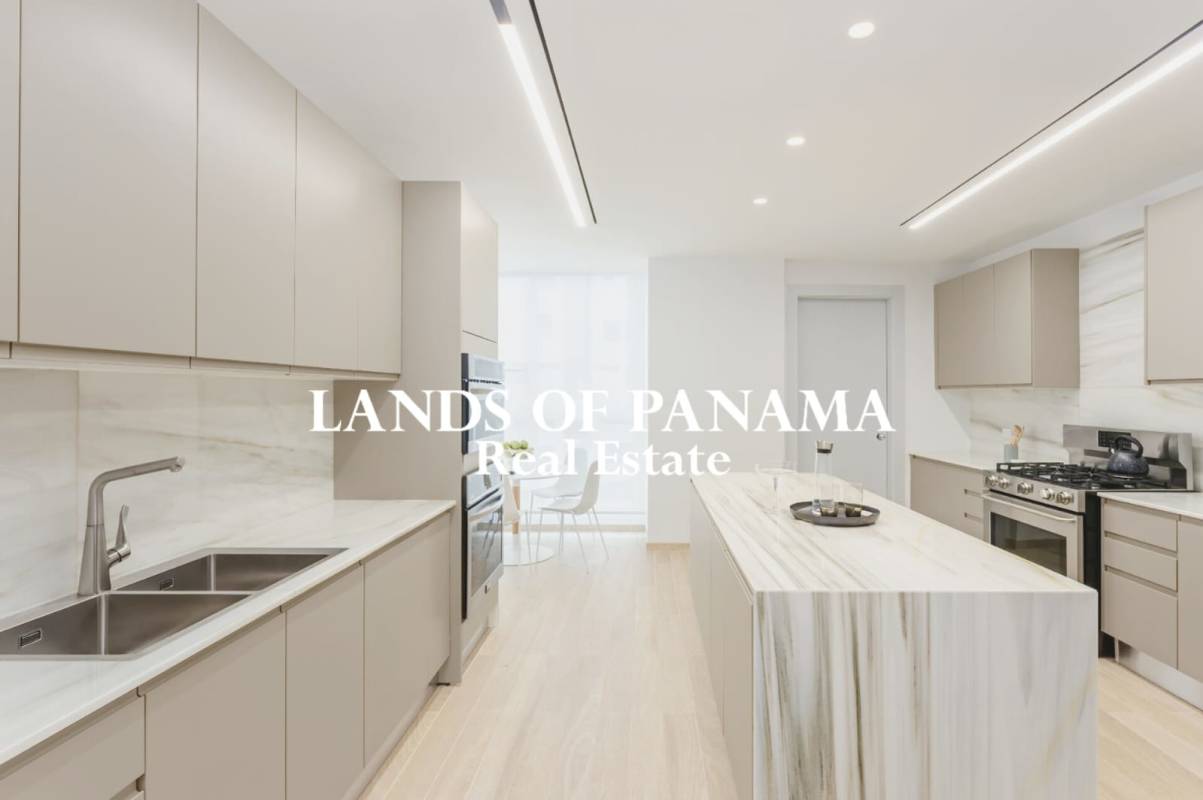 Living room with floor-to-ceiling windows and oceanfront balcony at PH The Towers Punta Paitilla