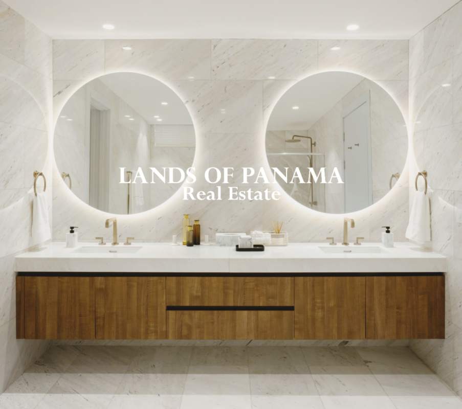 Modern bathroom with marble double sink vanity and circular backlit mirrors at PH The Towers Panama