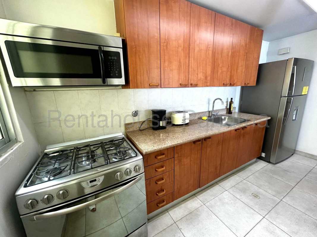 Bedroom with large window, ocean views, AC and modern decor in PH Terrawind Panama City