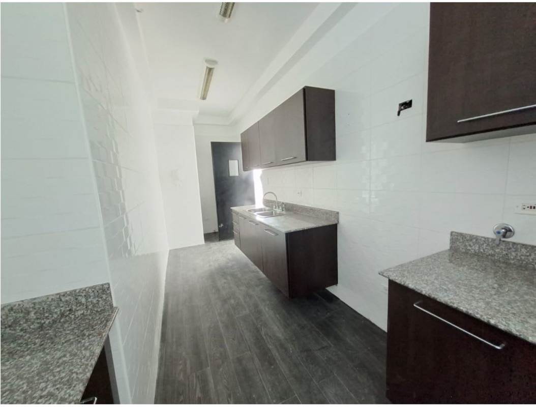 Galley style kitchen with granite countertops, dark cabinets, and tile backsplash in PH Belle View Panama City