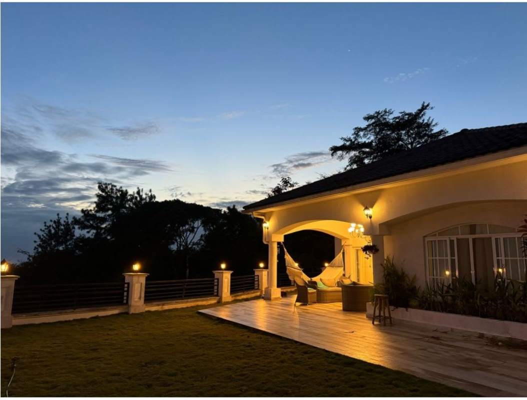 Spacious furnished living dining area chandelier double height ceiling natural light Cerro Azul