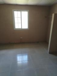 Bedroom space with light tiled floors and window in rental home Guadalupe La Chorrera