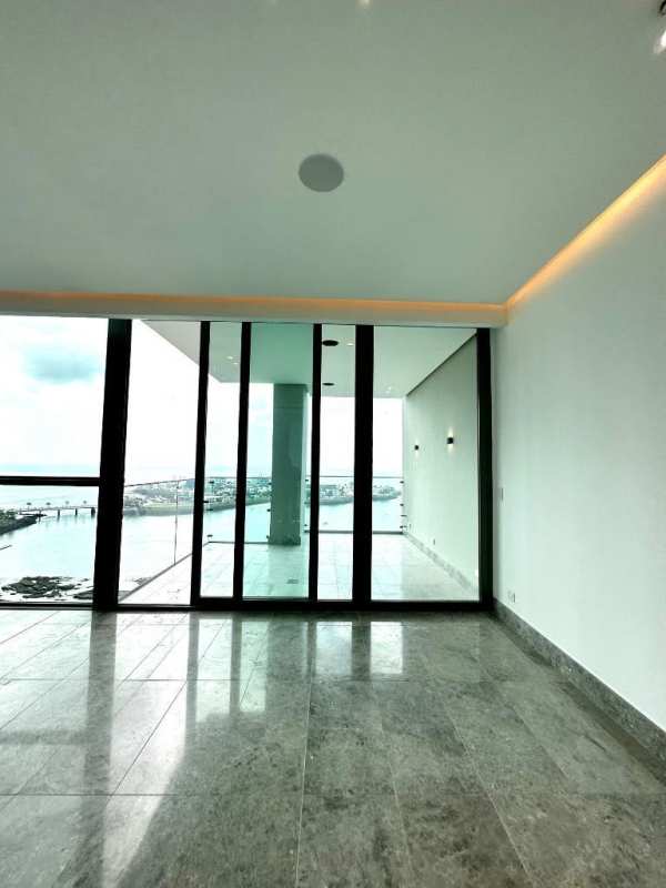 Long modern corridor with marble floors and recessed lighting at PH Punta Paitilla luxury condo Panama City