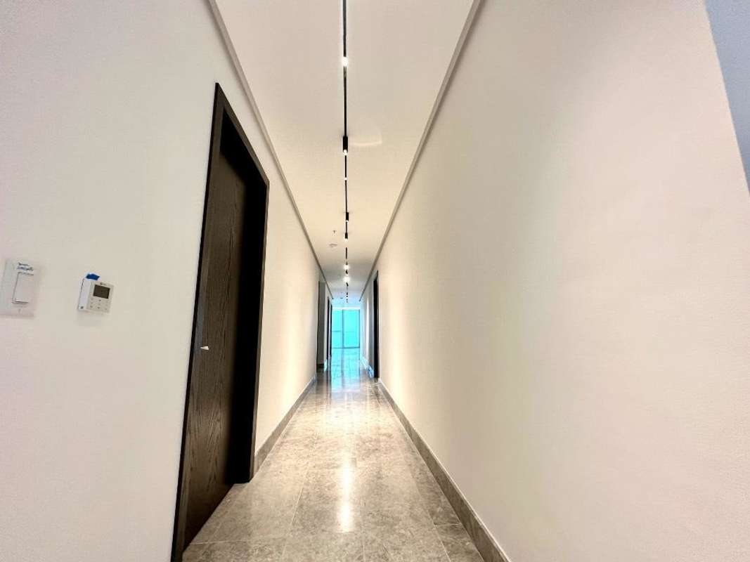 Modern living room with floor-to-ceiling windows offering city skyline and ocean view marble floors PH Punta Paitilla Panama