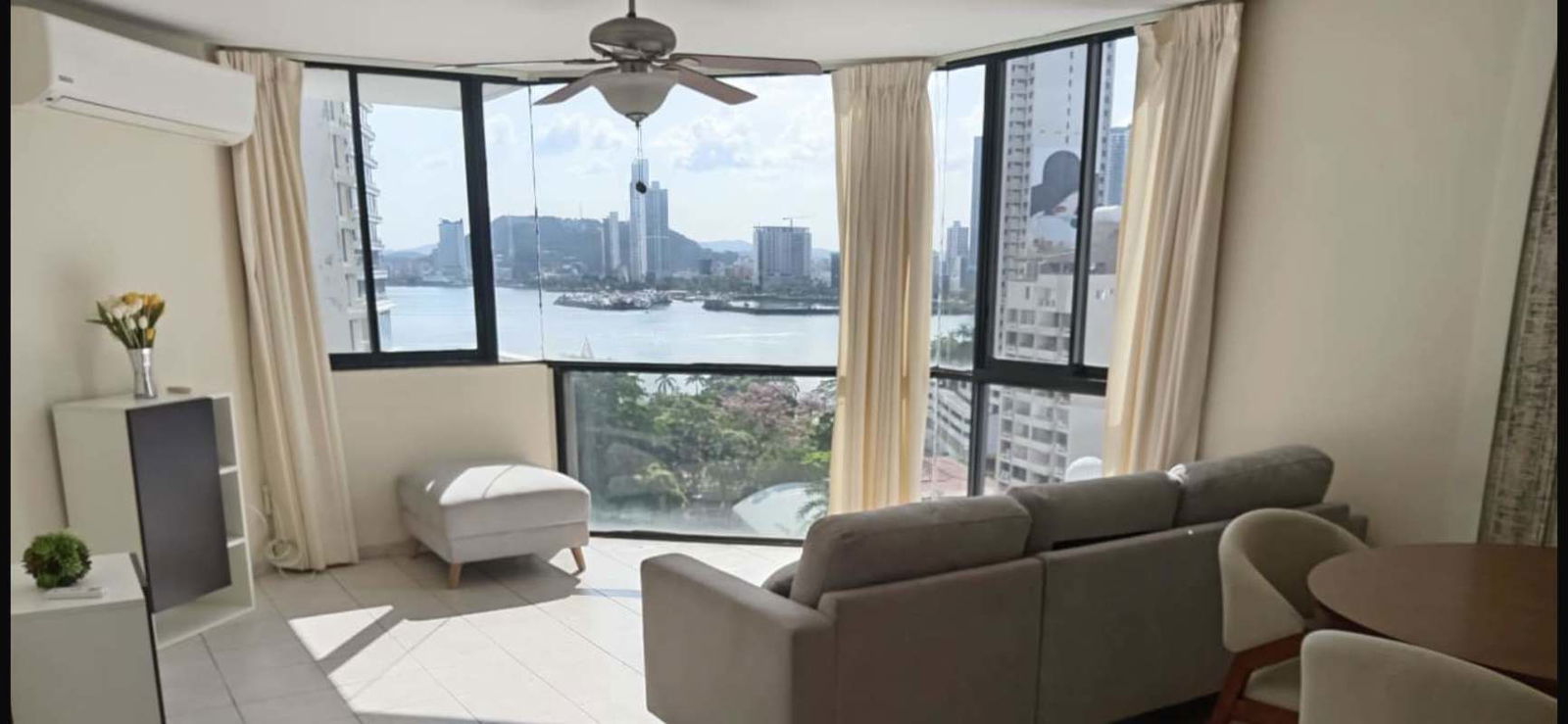 Panoramic windows with city skyline and bay view in furnished apartment Punta Paitilla