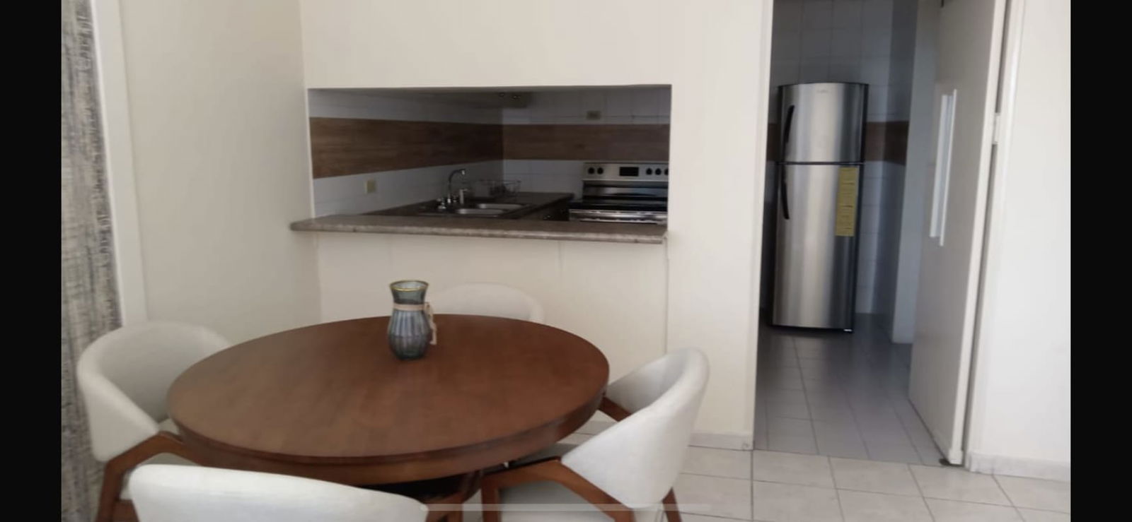 Kitchen with granite, dining space, stainless appliances in Punta Paitilla apartment