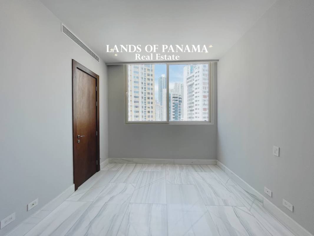Spacious minimalist kitchen with central marble island and large windows at PH The Towers Panama