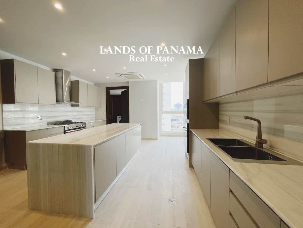 Spacious bedroom with marble flooring, large window overlooking Panama skyline at PH The Towers Panama