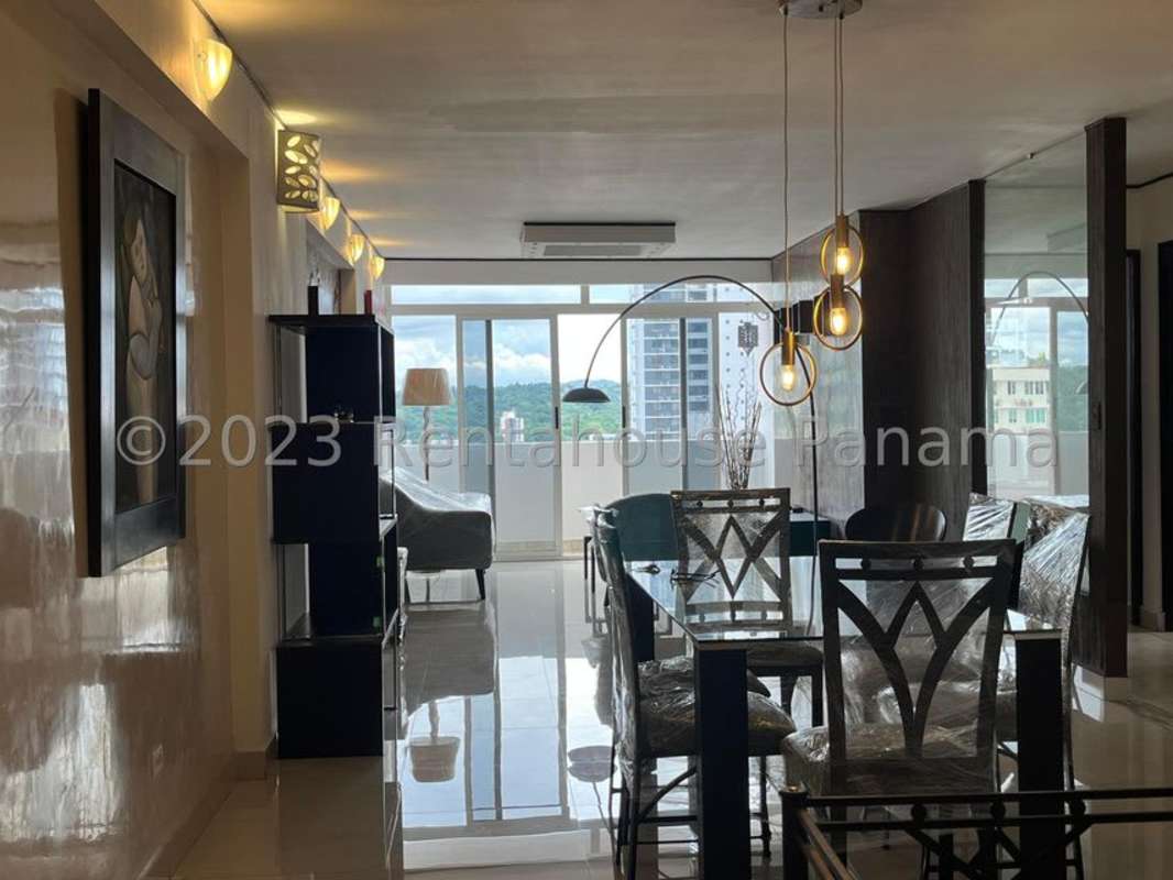 Open living and dining area with balcony at PH Villa Cangrejo Panama