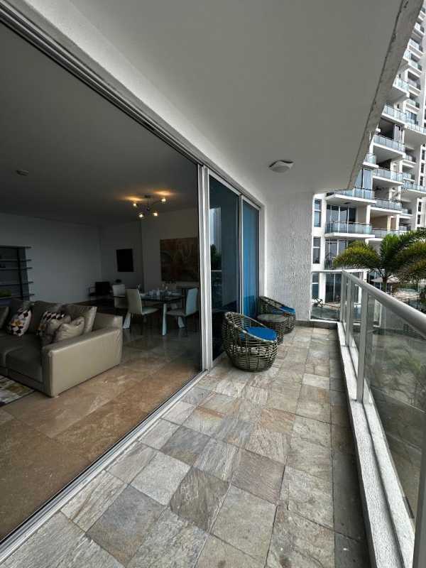 Elegant dining area with marble flooring adjacent to ocean-view balcony at Punta Pacifica condo Panama City