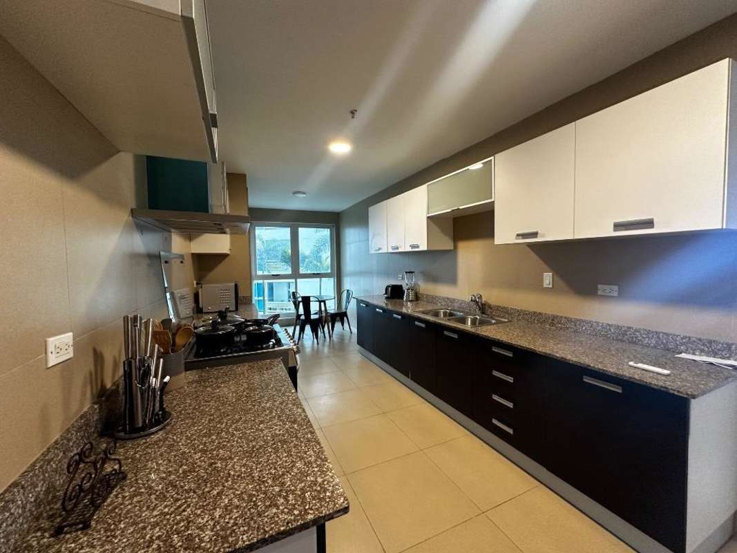 Spacious open concept living and dining room with marble floors in Ocean Club Punta Pacifica Panama