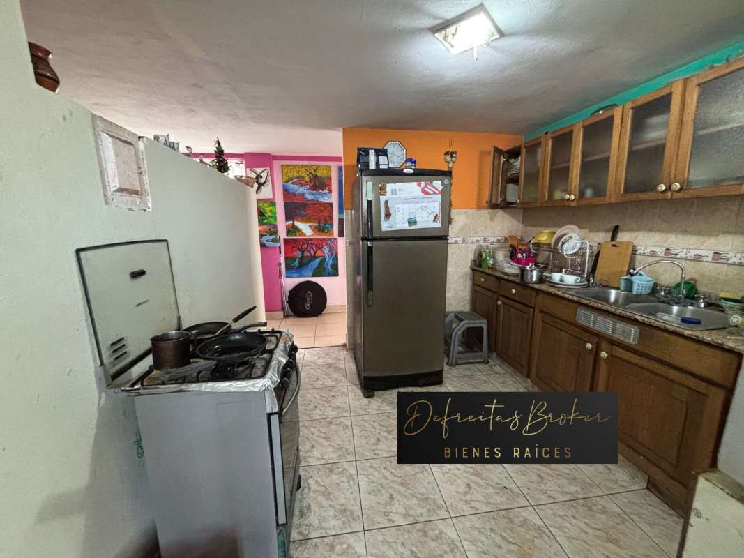 Colorful kitchen with stove refrigerator tile floor PH Deby Parque Lefevre Panama