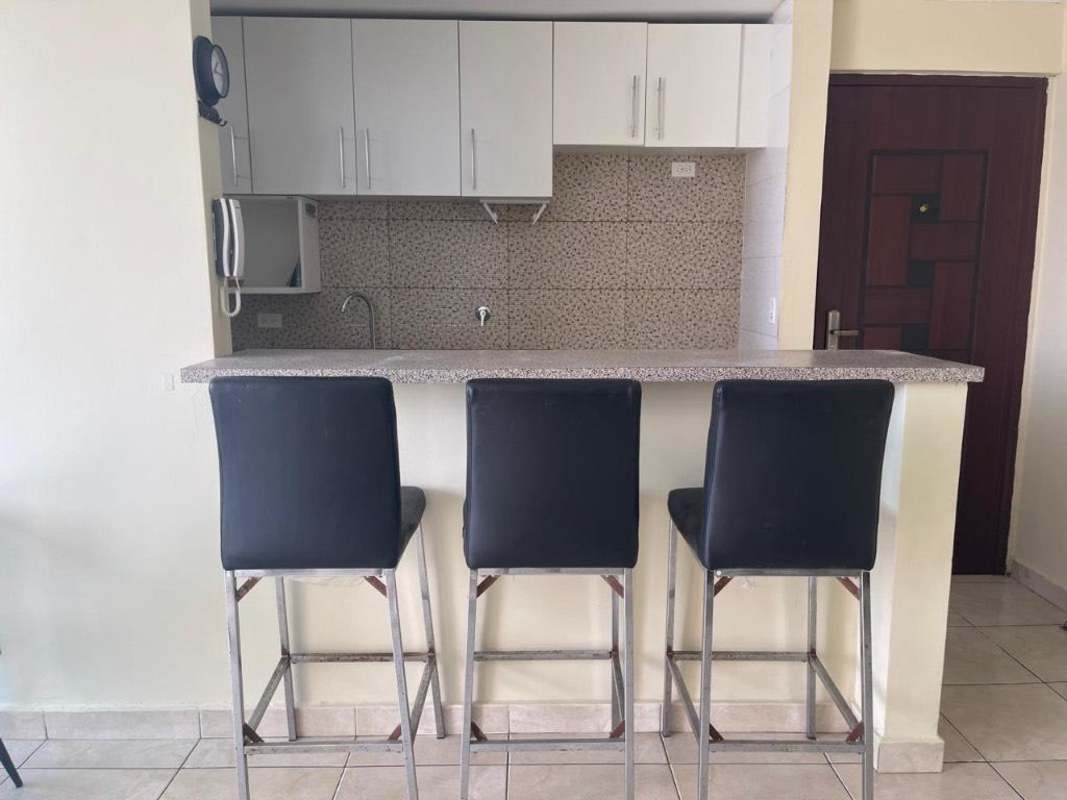 Dining area with granite-topped breakfast bar and seating in apartment for rent El Crisol Villa Lucre Panama