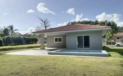 Large communal swimming pool with landscaped gardens in Villas del María Bejuco Chame Panama
