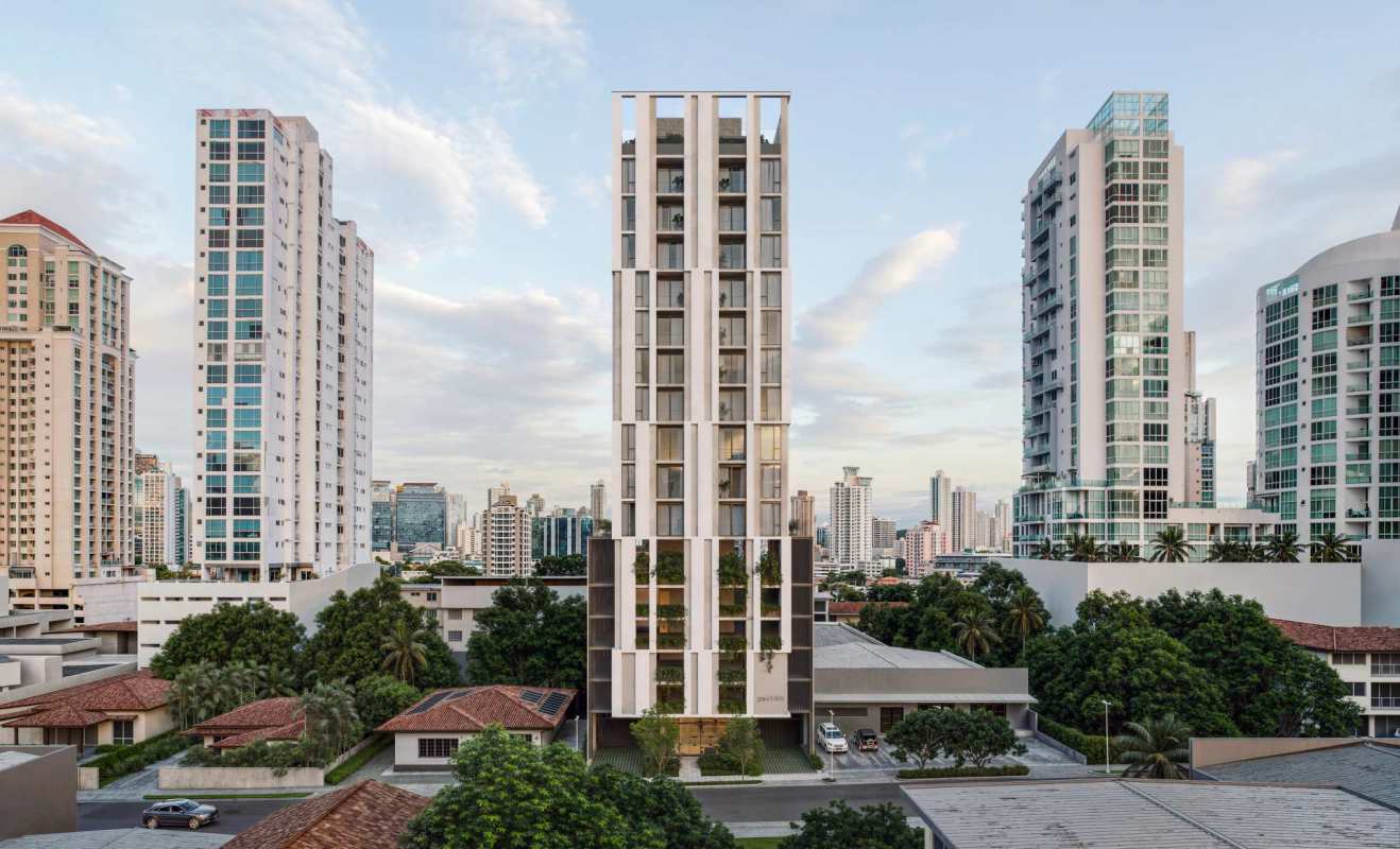 Open-plan condo interior in Gesti68 Tower featuring customizable kitchen, dining space and balcony with views of Panama City