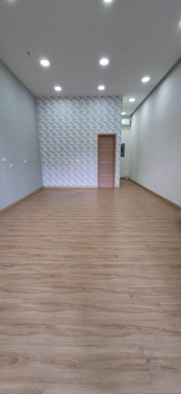 Ground floor retail or office space with wood flooring and geometric wallpaper in Obarrio Panama