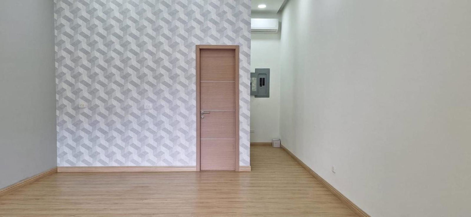 Modern minimalist empty retail or office with wood floors and accent wall Obarrio Panama