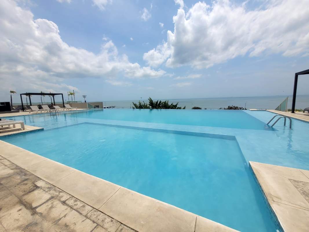 Bright minimalist bedroom with ceramic tile floor and city view window PH Terramar Panama