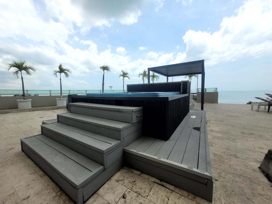 Rooftop deck with seating and plunge pool with glass railing at PH Terramar San Francisco Panama