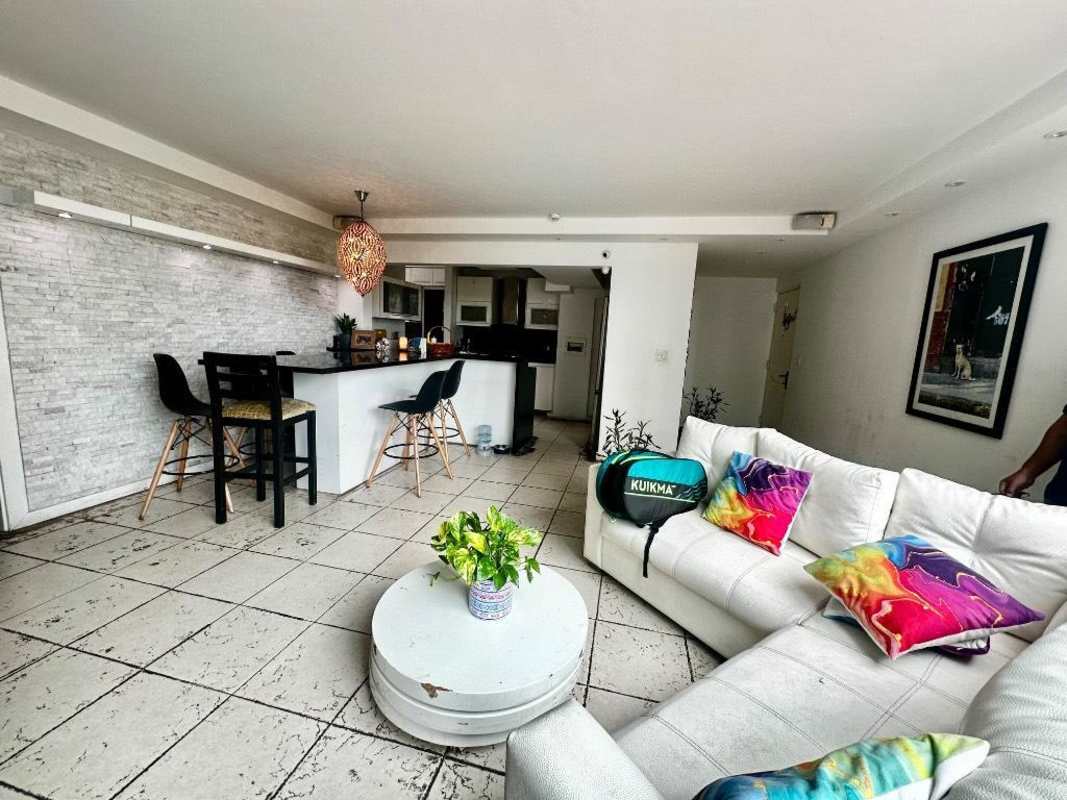 Bright living and dining area with large windows, city view in PH Quartz Panama City apartment