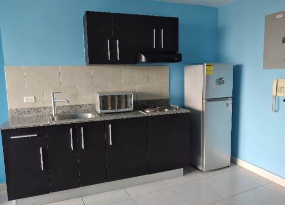 Small kitchen area with fridge, cooktop, granite counters in PH Bay View Panama