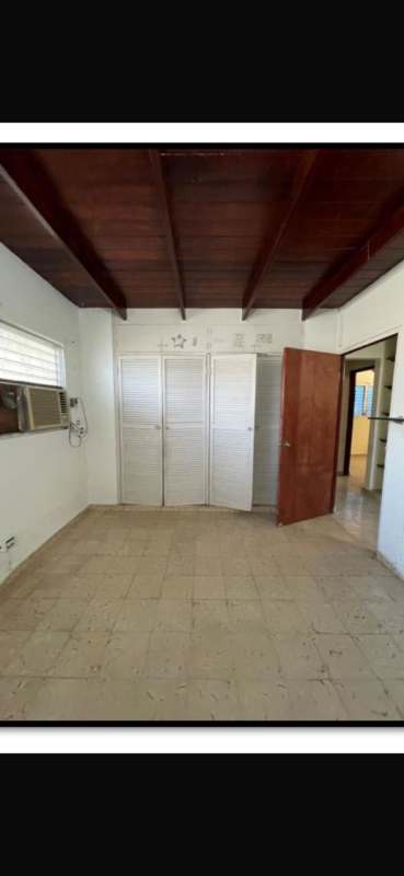 Bedroom with wooden beams, closet, tile floor house for sale Villa de las Fuentes Panama