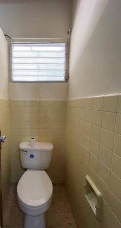 Open living dining room with large windows wooden beams tile floor house sale Panama