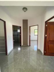 Modern kitchen with marble countertop island, white subway backsplash and large window at Boquete Canyon Village