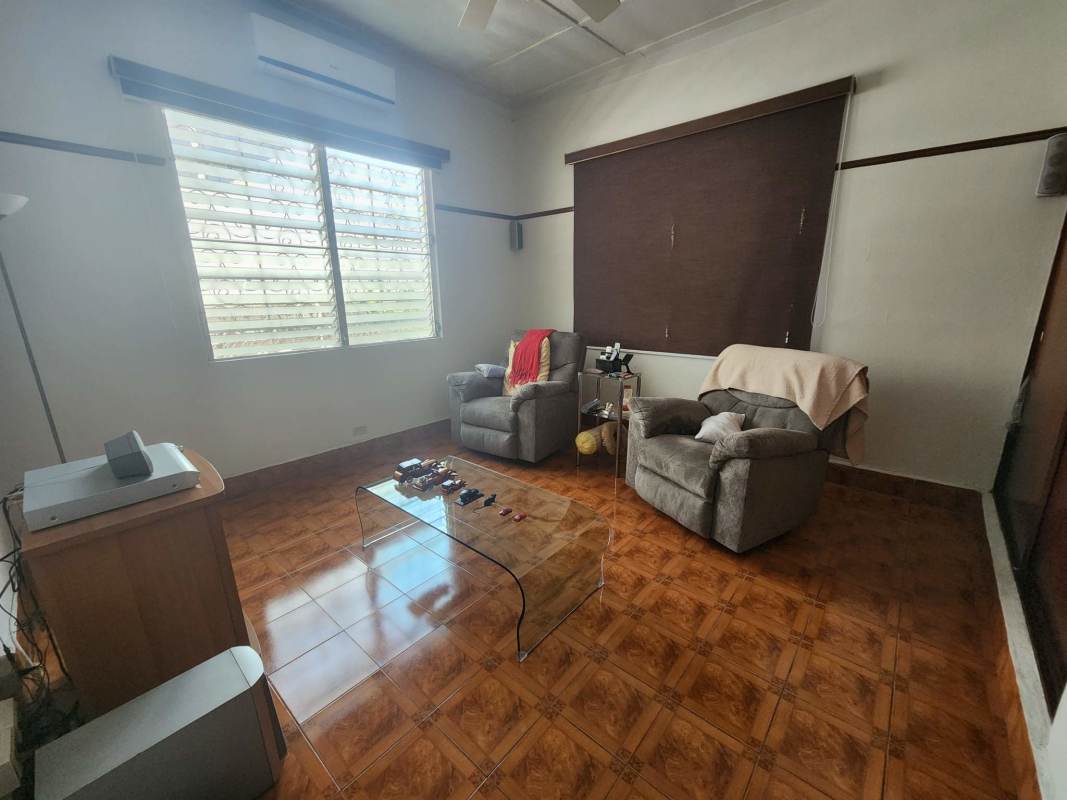 Dining/conference space with large window curtains tile floors in commercial house Coco del Mar Panama