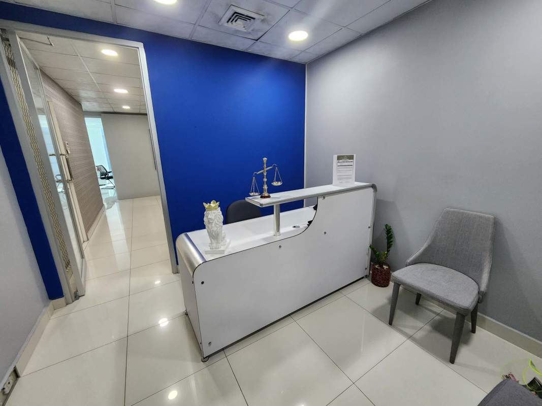 Reception area with accent blue wall and counter in Oceania Business Plaza Panama