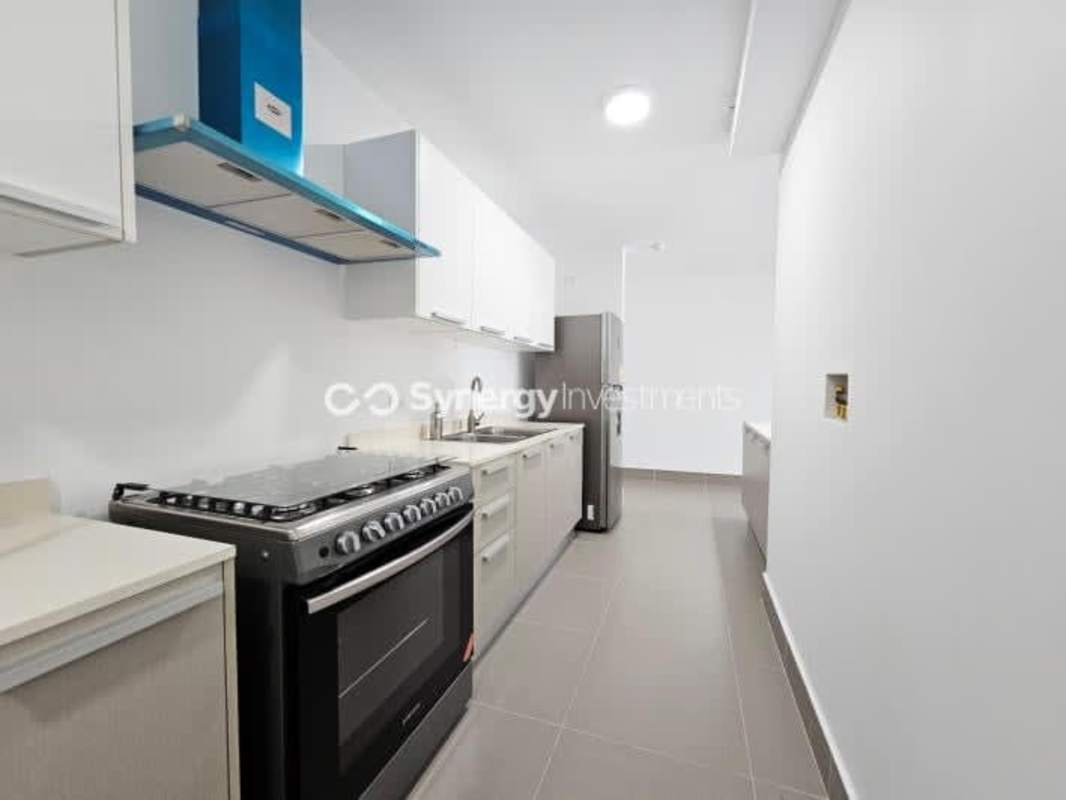 Open living room with sliding doors to balcony and panoramic views PH Aqualina Bella Vista