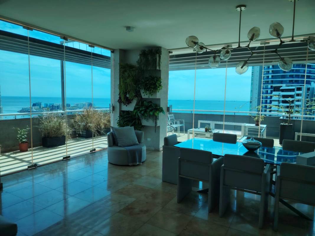 Spacious living room with double-height windows, panoramic ocean views, chandelier in Punta Paitilla Penthouse