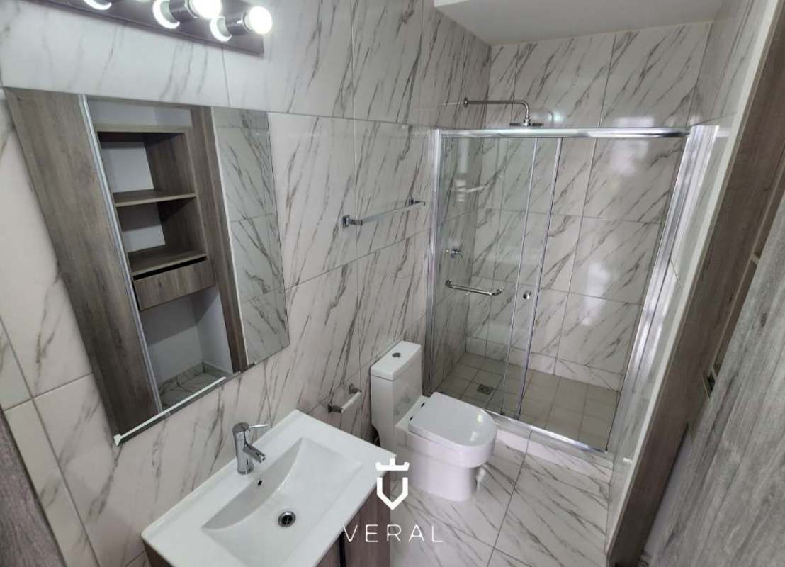 Bathroom with glass shower marble tile modern fixtures in PH The Grey Calle 50