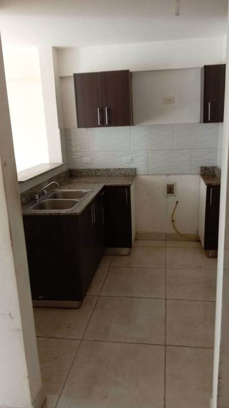 Compact kitchen with granite countertop, cabinets and tile backsplash in apartment at PH Terrazas de Villa Zaita Las Cumbres Panama
