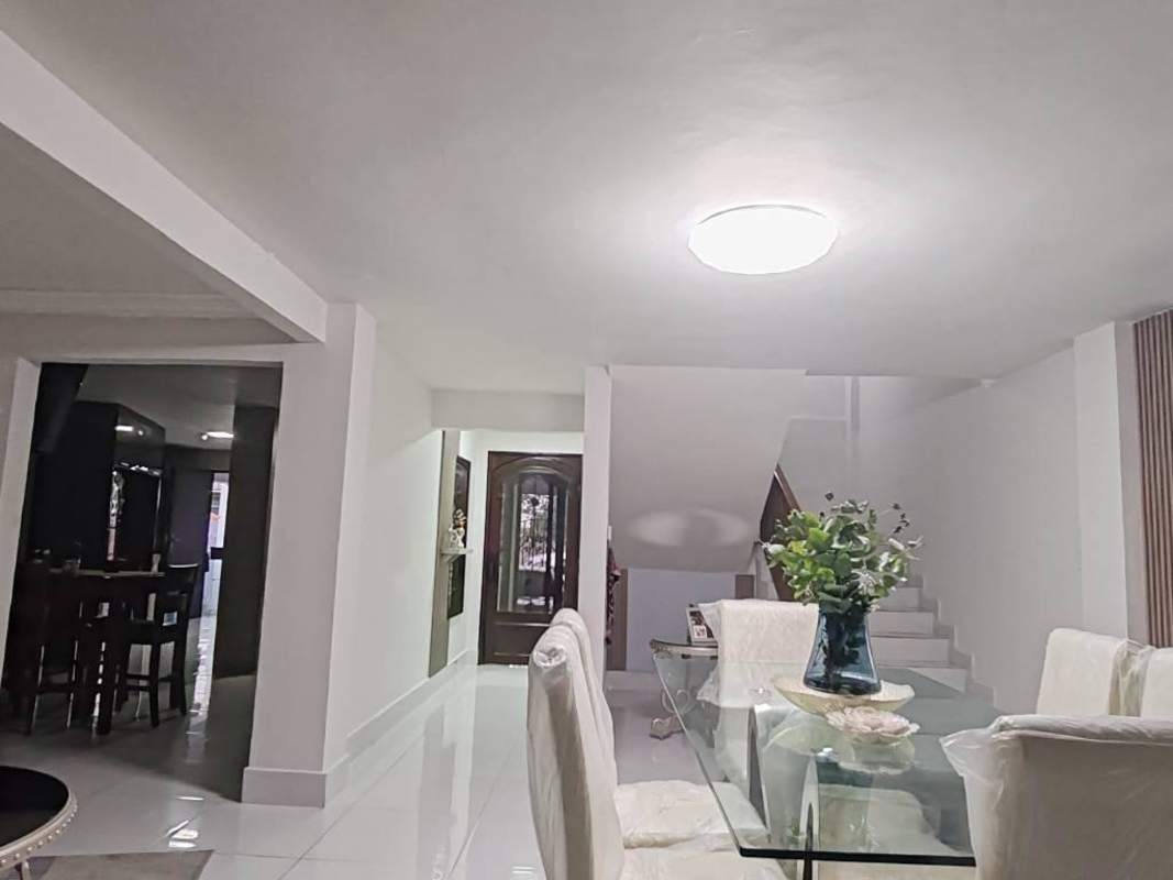 Kitchen with granite countertops, breakfast area and white cabinets in Condado del Rey Panama rental home