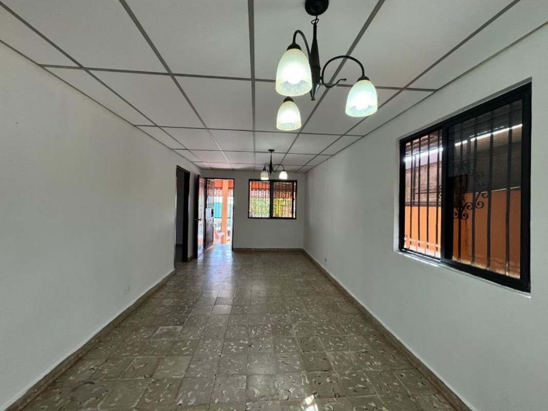 Empty interior living space with tiled floor and white walls in house for sale Colinas del Prado Panama City