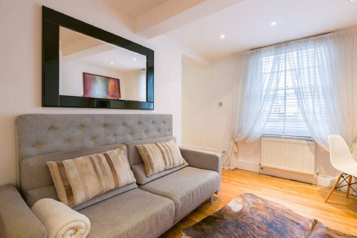 Comfortable bedroom featuring wooden flooring, large windows, city view in Yoo Panama for rent