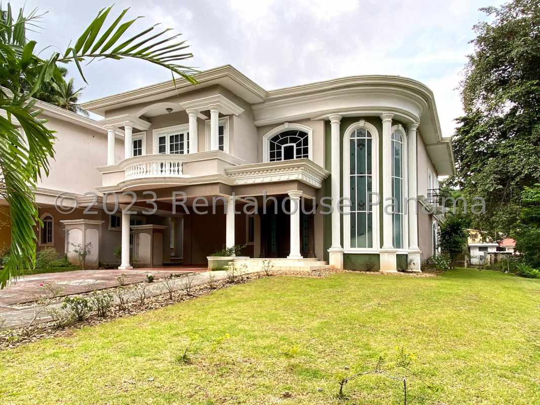 Outdoor patio area with columns, tiled floor, porch swing and backyard garden Albrook Panama