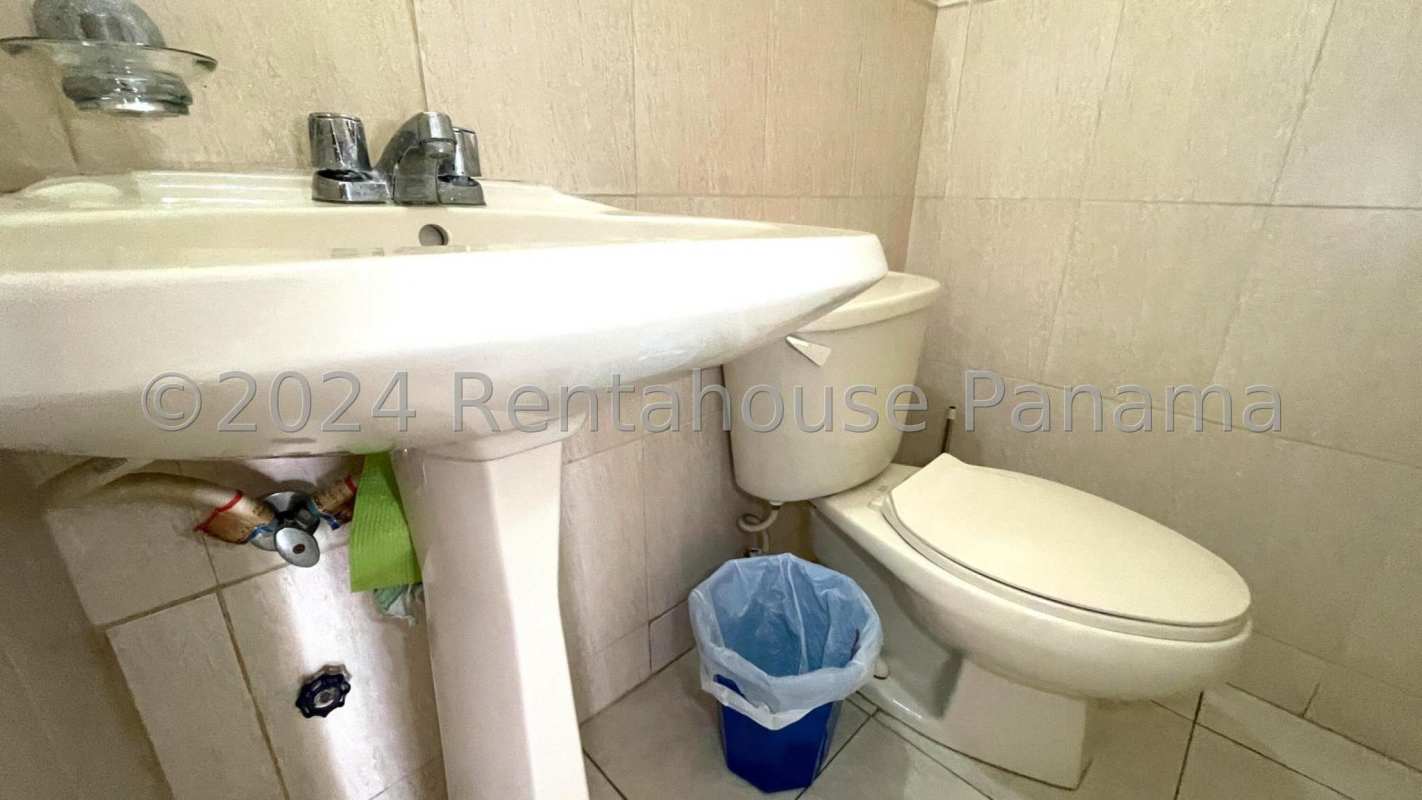 Classic kitchen with granite countertop, wood cabinetry, and tile backsplash in Dorado Lakes home Panama