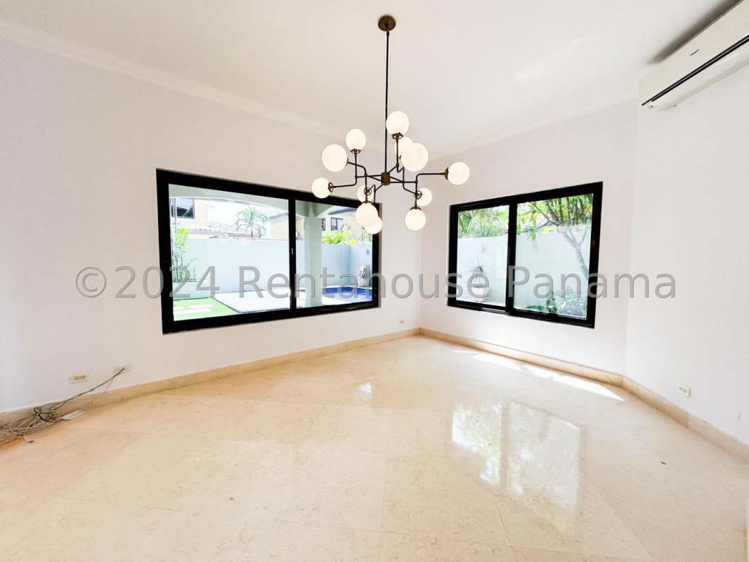 Spacious kitchen with granite counters, central island, built-in ovens in Costa del Este luxury house Panama City