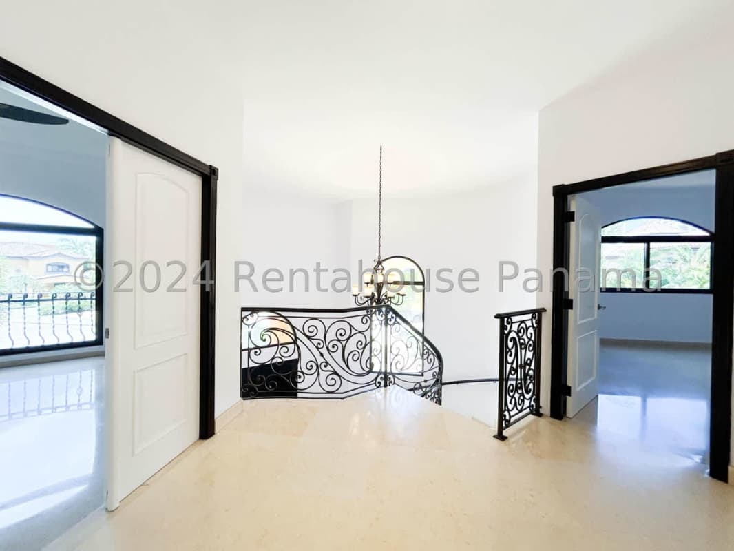 Bright living room with marble flooring, large windows, ceiling chandelier in luxury Costa del Este home Panama