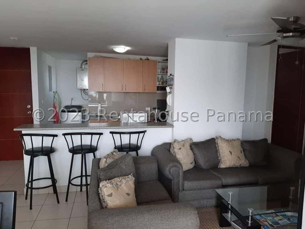 Kitchen with granite countertop, wood cabinets, fridge and microwave at PH Central Park 12 de Octubre