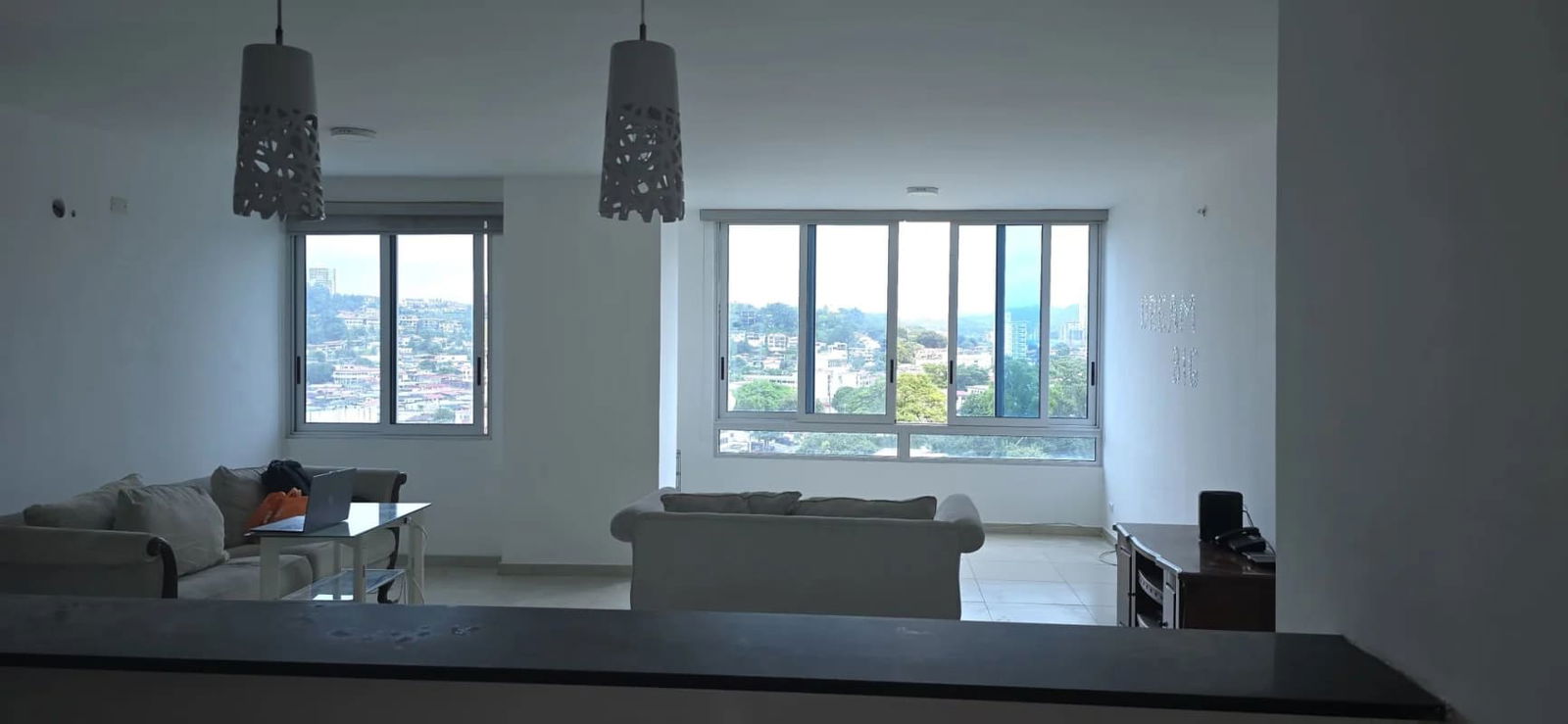 Spacious living area with large windows and city view at PH Macedonia Towers in El Ingenio Panama City
