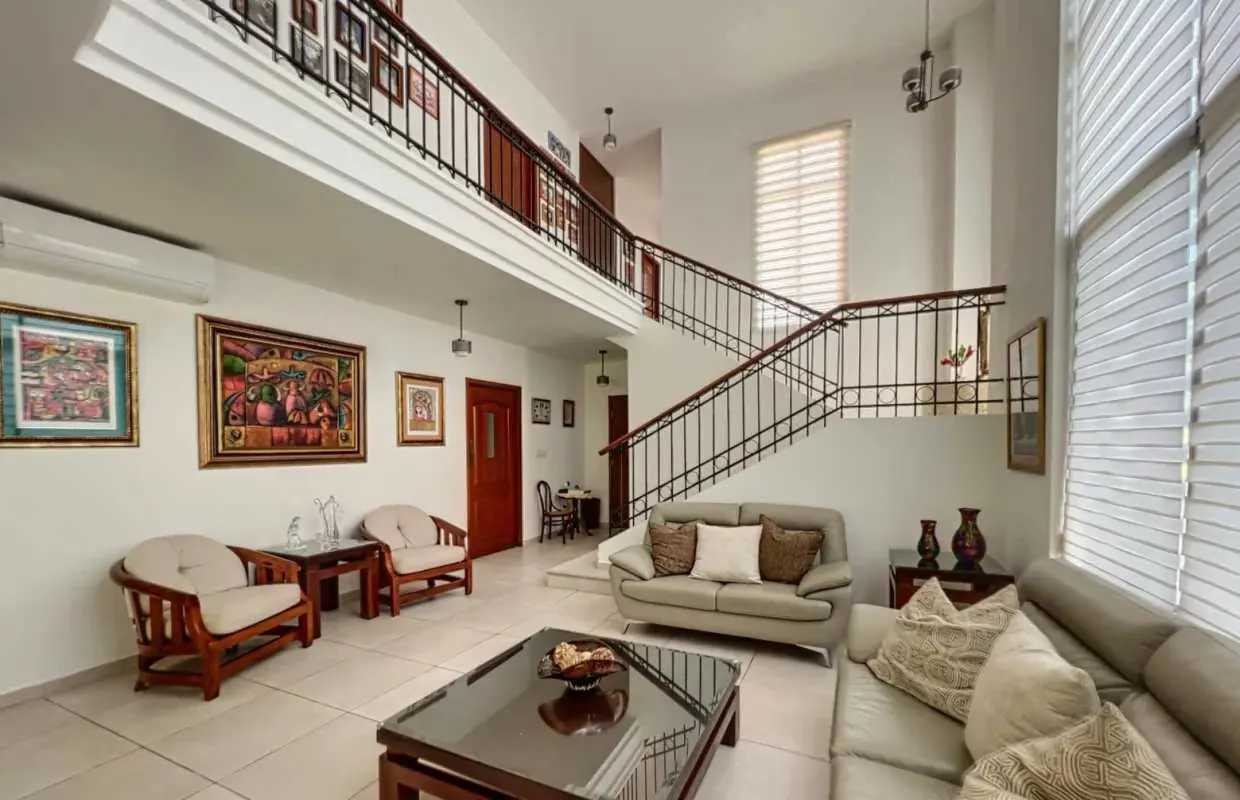 Dining area with large windows overlooking lush garden Senderos de Camino de Cruces Clayton Panama